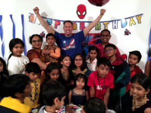 washington-dc-magic-birthday-shows-for-kids-raises his arms in celebration among children at a Spider-Man themed birthday party.